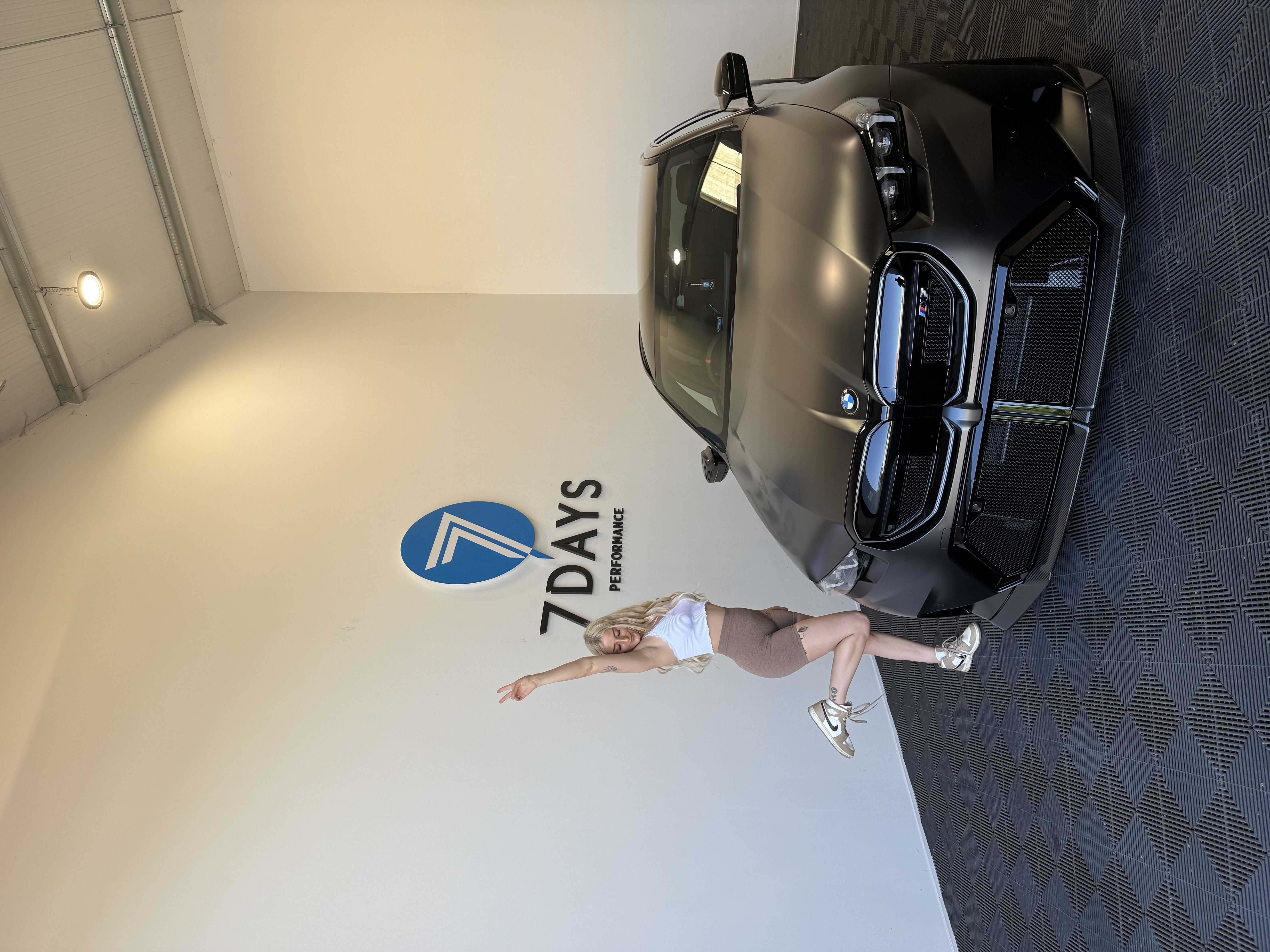 Jess beside a BMW at 7Days Performance